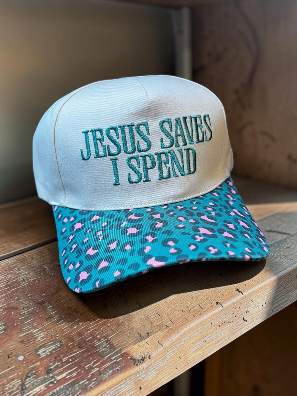 White Cap with Teal & Pink Leopard Brim - Embroidered 'Jesus Saves I Spend'